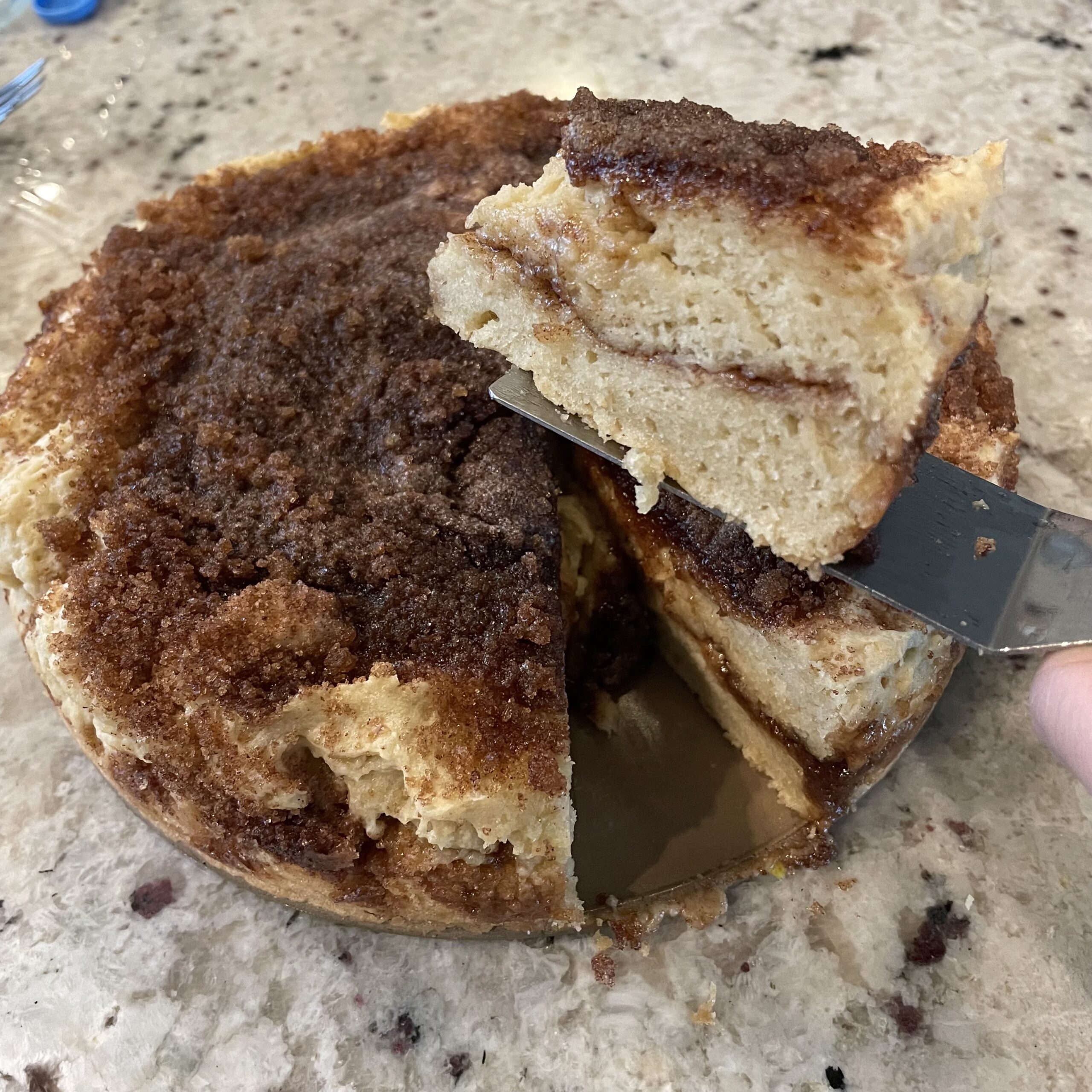 Coffee cake with one slice cut out to serve.